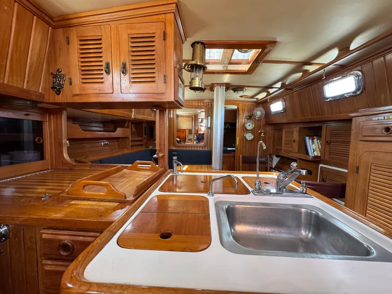 Slide: The Image of Interior of 1988 Cabo Rico 38XL yacht with wooden cabinetry and stainless steel sink. - 28
