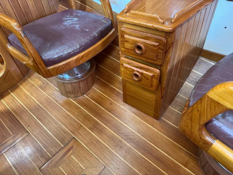 Slide: The Image of Wooden interior of a 1988 Cabo Rico 38XL yacht with leather seats and storage drawers. - 34