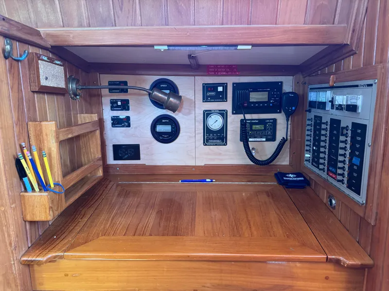 Slide: The Image of Navigation station of a 1988 Cabo Rico 38XL yacht with control panels and instruments. - 43