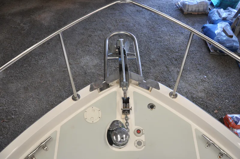 Slide: The Image of Bow of 2005 True North 33 boat with anchor and railing in a storage area. - 10