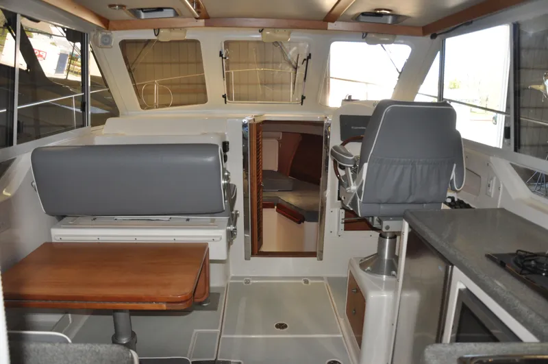 Slide: The Image of Interior of 2005 True North 33 boat with seating, table, and helm station. - 15