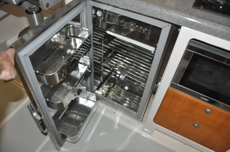 Slide: The Image of Open stainless steel refrigerator in a 2005 True North 33 boat kitchen. - 18