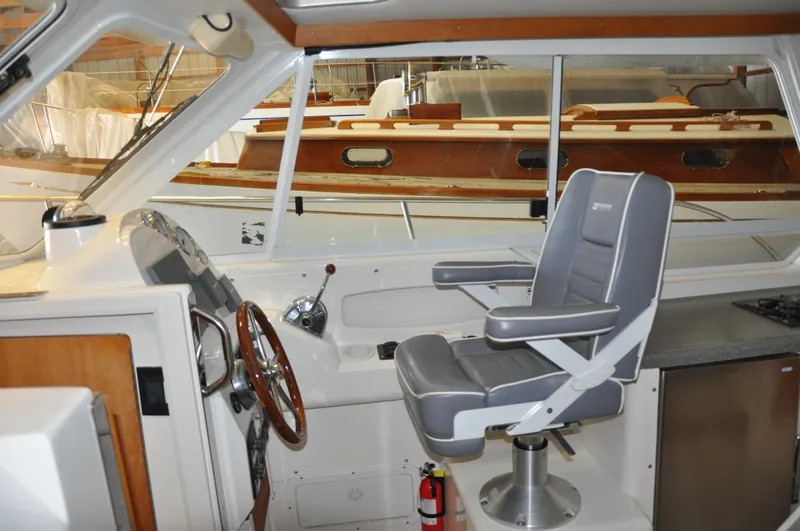 Slide: The Image of Interior of 2005 True North 33 boat with helm station and captain's chair. - 19