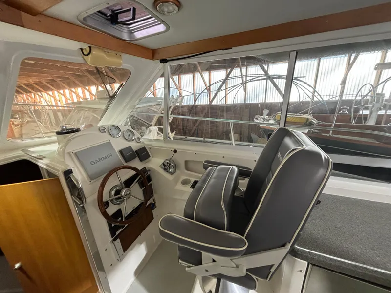 Slide: The Image of 2005 True North 33 boat interior with steering wheel and navigation equipment. - 20