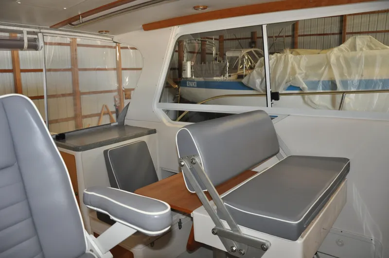 Slide: The Image of Interior of 2005 True North 33 boat with gray seating and wooden accents. - 22