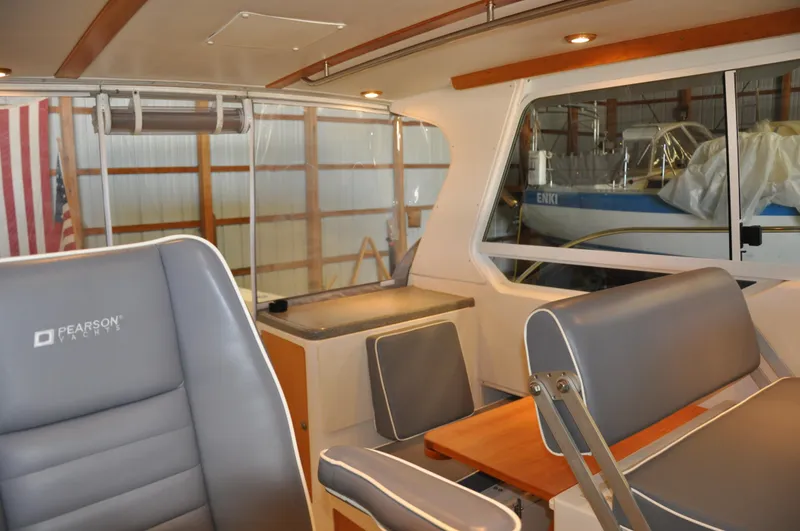 Slide: The Image of Interior of 2005 True North 33 boat with gray seating and wooden accents. - 23