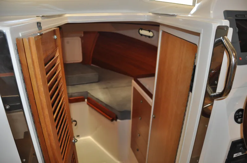Slide: The Image of Interior cabin of a 2005 True North 33 boat with wooden finishes and seating area. - 24