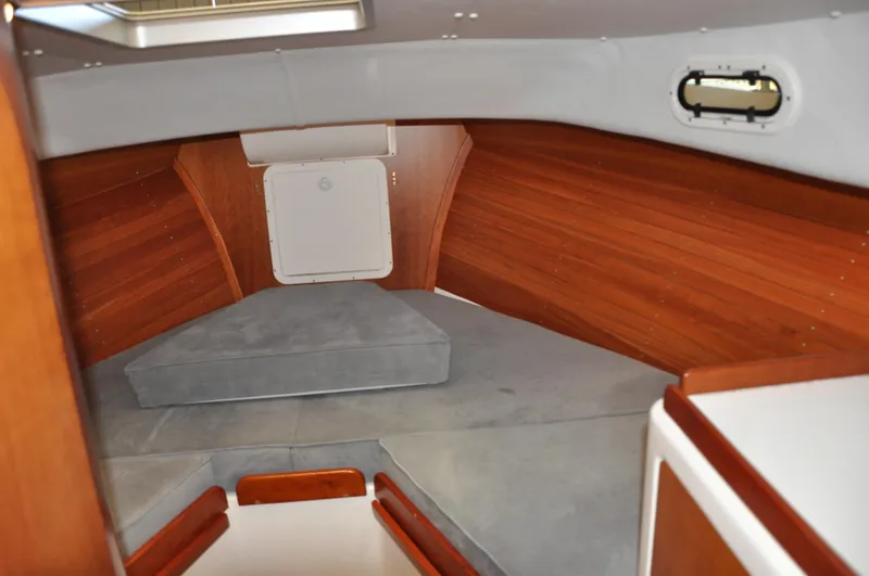 Slide: The Image of Interior of 2005 True North 33 boat with wooden paneling and cushioned seating. - 26