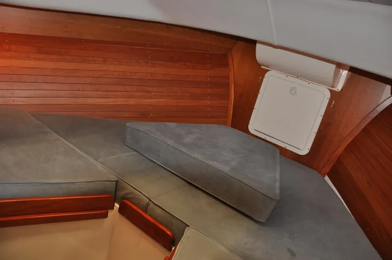 Slide: The Image of Interior cabin of 2005 True North 33 boat with wooden paneling and cushioned seating. - 27