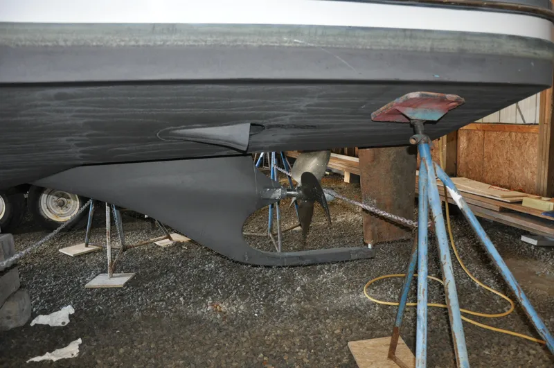 Slide: The Image of 2005 True North 33 boat hull and propeller on stands in a workshop. - 36