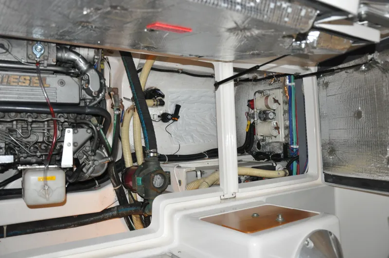 Slide: The Image of Engine compartment of a 2005 True North 33 boat, showcasing mechanical components and wiring. - 42