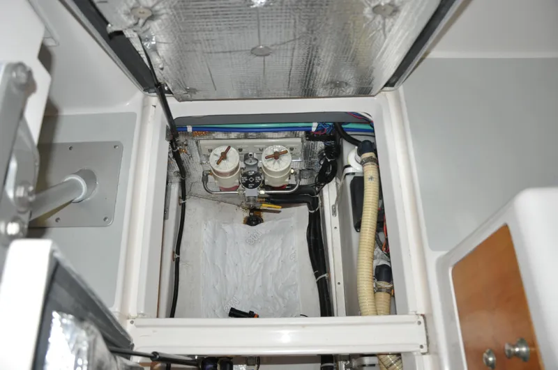 Slide: The Image of Engine compartment of a 2005 True North 33 boat, showing fuel filters and hoses. - 43