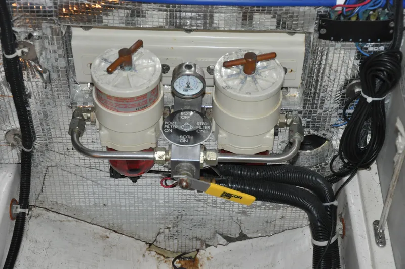 Slide: The Image of Engine compartment of 2005 True North 33 with dual fuel filters and control valve. - 44