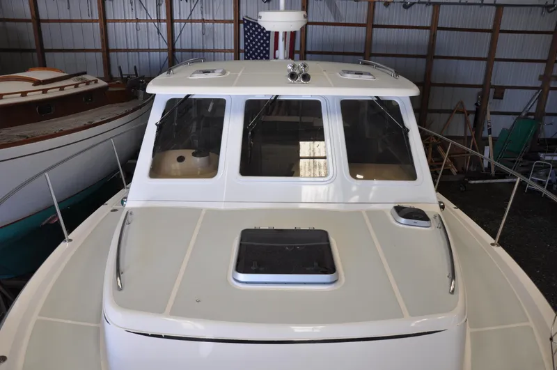 Slide: The Image of 2005 True North 33 boat in storage, front view with windows and hatch. - 8