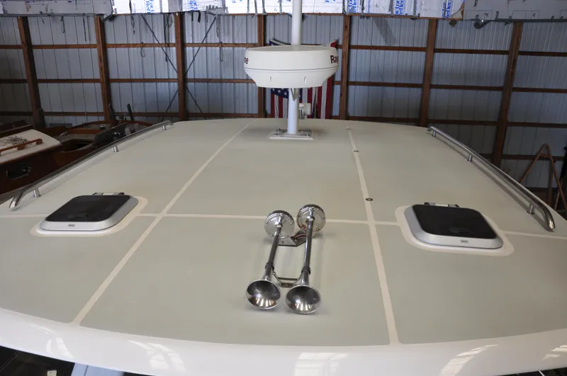 Slide: The Image of Rooftop view of 2005 True North 33 boat in storage, featuring hatches and radar. - 9