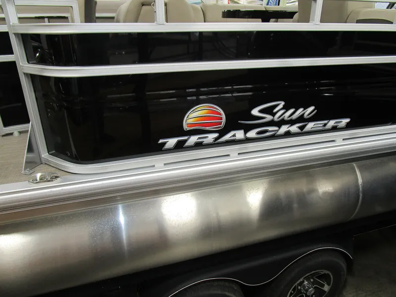 Slide: The Image of 2025 Sun Tracker Sport Fish 22 pontoon boat with sleek black exterior design. - 10