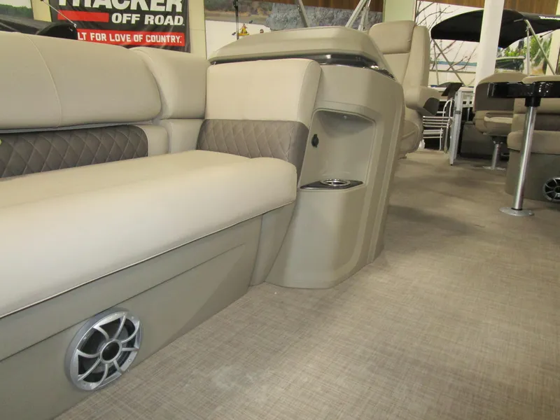 Slide: The Image of 2025 Sun Tracker Sport Fish 22 interior with beige seating and speaker detail. - 4
