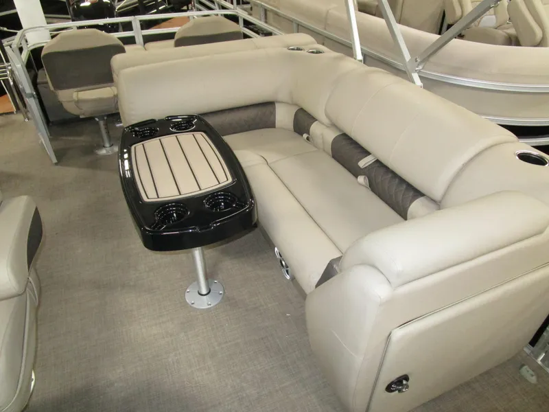 Slide: The Image of 2025 Sun Tracker Sport Fish 22 pontoon boat interior with beige seating and table. - 5