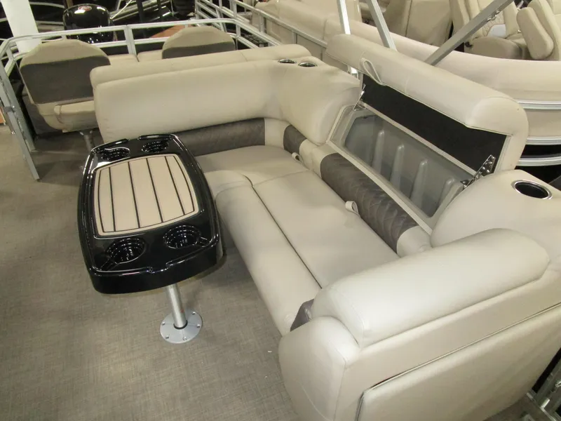 Slide: The Image of 2025 Sun Tracker Sport Fish 22 interior with beige seating and a central table. - 6