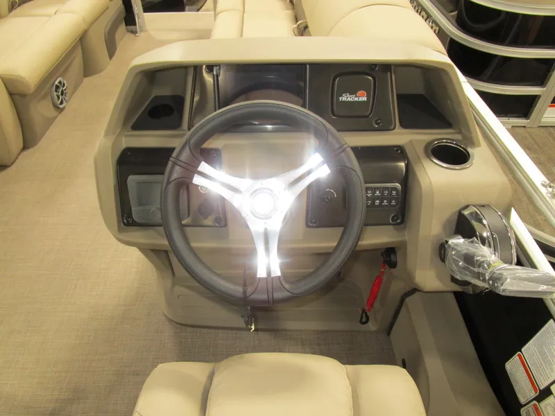 Slide: The Image of 2025 Sun Tracker Sport Fish 22 dashboard with steering wheel and controls. - 7