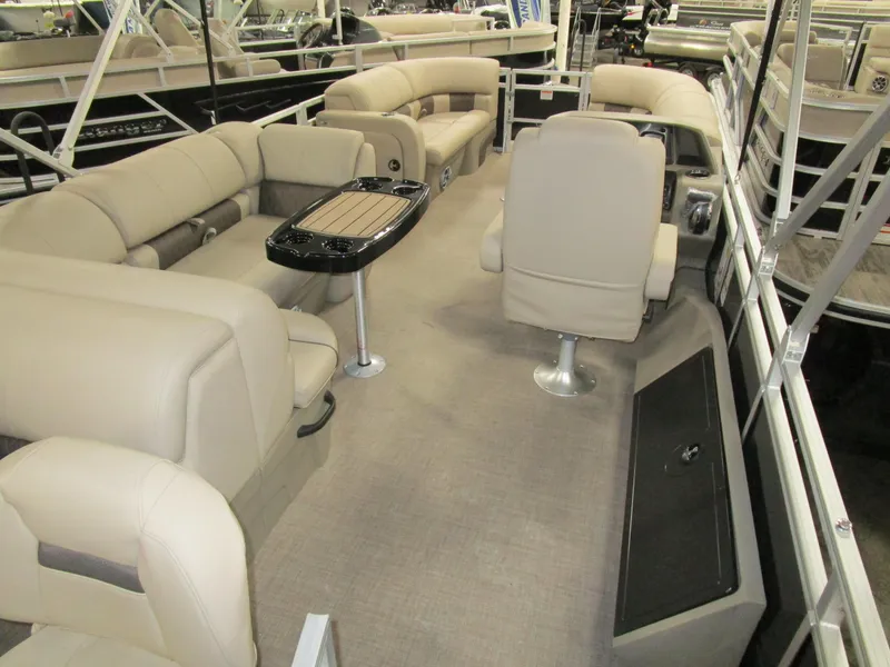 Slide: The Image of 2025 Sun Tracker Sport Fish 22 pontoon boat interior with beige seating and table. - 9