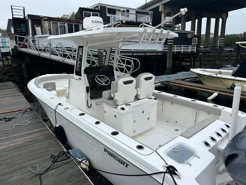 Slide: The Image of 2022 Pursuit S 268 boat docked, featuring a sleek design and modern amenities. - 1