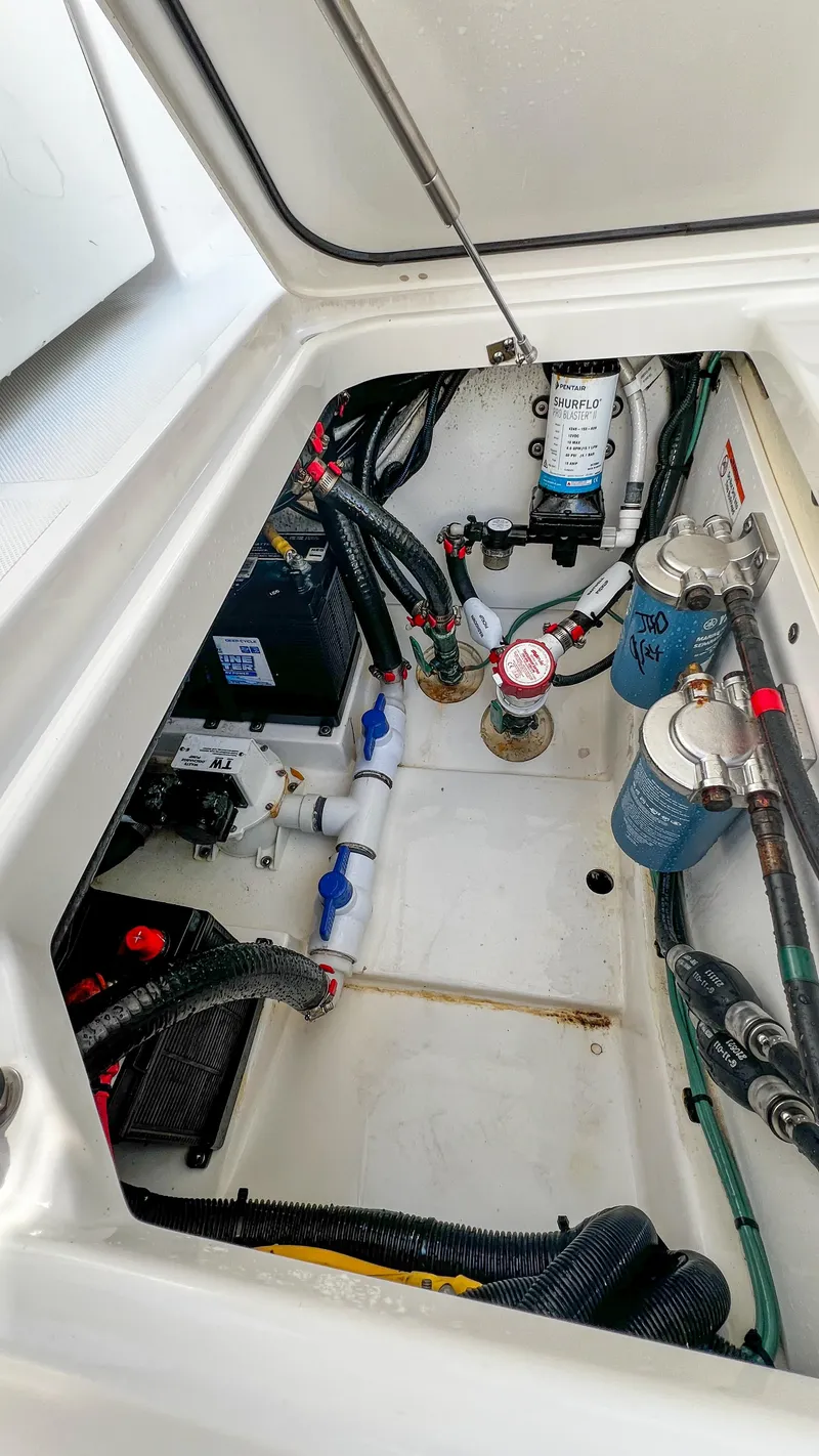 Slide: The Image of 2022 Pursuit S 268 boat engine compartment with wiring and components. - 14