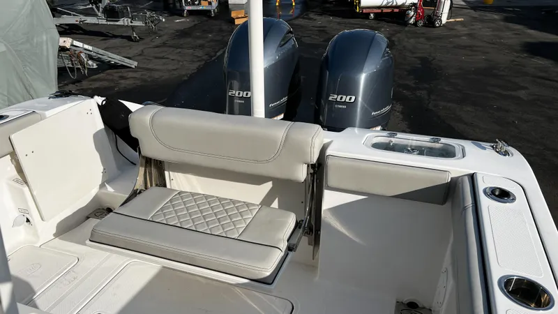 Slide: The Image of 2022 Pursuit S 268 boat with dual 200 horsepower engines and cushioned seating. - 19