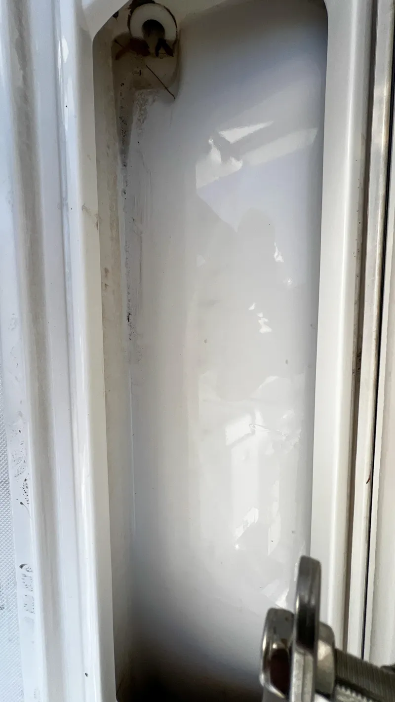 Slide: The Image of Close-up of a 2022 Pursuit S 268 boat compartment with latch detail. - 21