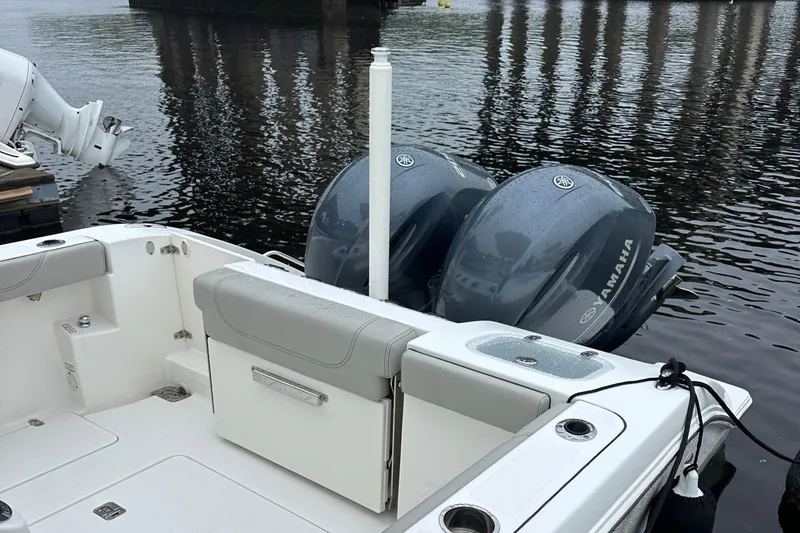 Slide: The Image of 2022 Pursuit S 268 boat with dual Yamaha engines, docked on calm water. - 5