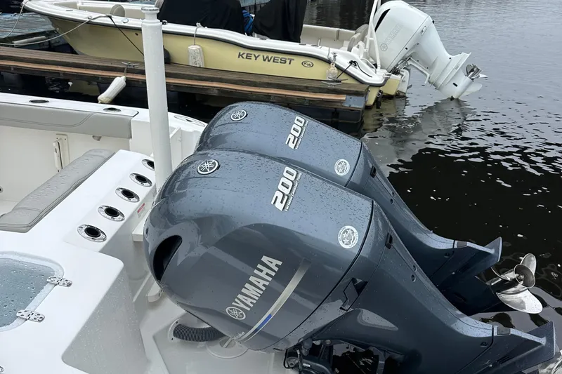 Slide: The Image of Twin Yamaha 200 engines on a 2022 Pursuit S 268 boat at a dock. - 8