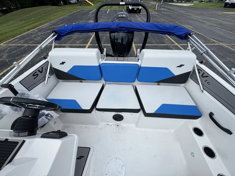 Slide: The Image of The image shows the cockpit of a 2025 Starcraft SV 16 OB with blue and white seating. - 4