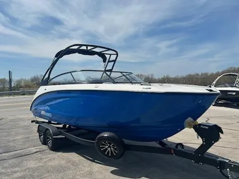 Slide: The Image of 2025 Yamaha Boats AR250, blue and white, on trailer, parked outdoors under a clear sky. - 3