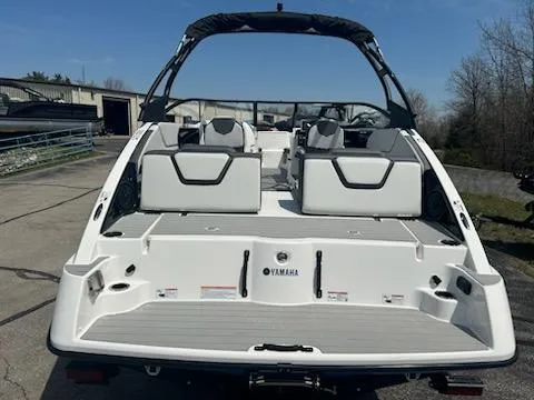 Slide: The Image of 2025 Yamaha Boats AR250, rear view, white exterior, spacious seating, outdoor setting. - 5
