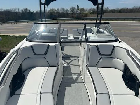 Slide: The Image of 2025 Yamaha Boats AR250 interior with sleek white seating and modern design. - 8