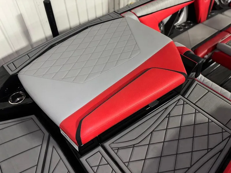 Slide: The Image of 2018 Tigé RZX3 boat interior with red and gray diamond-stitched upholstery. - 10