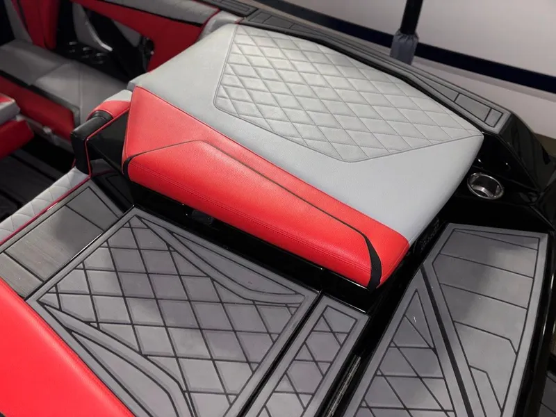 Slide: The Image of 2018 Tigé RZX3 boat interior with red and gray diamond-stitched upholstery. - 11