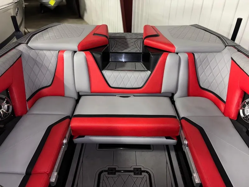 Slide: The Image of 2018 Tigé RZX3 boat interior with red and gray seating, featuring quilted patterns. - 13