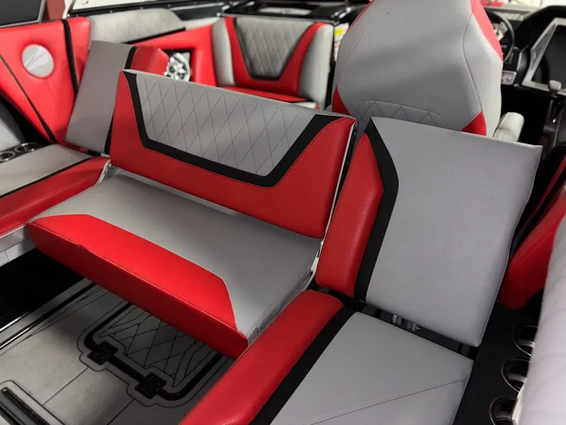 Slide: The Image of 2018 Tigé RZX3 boat interior with red and gray seating, featuring modern design and comfort. - 16