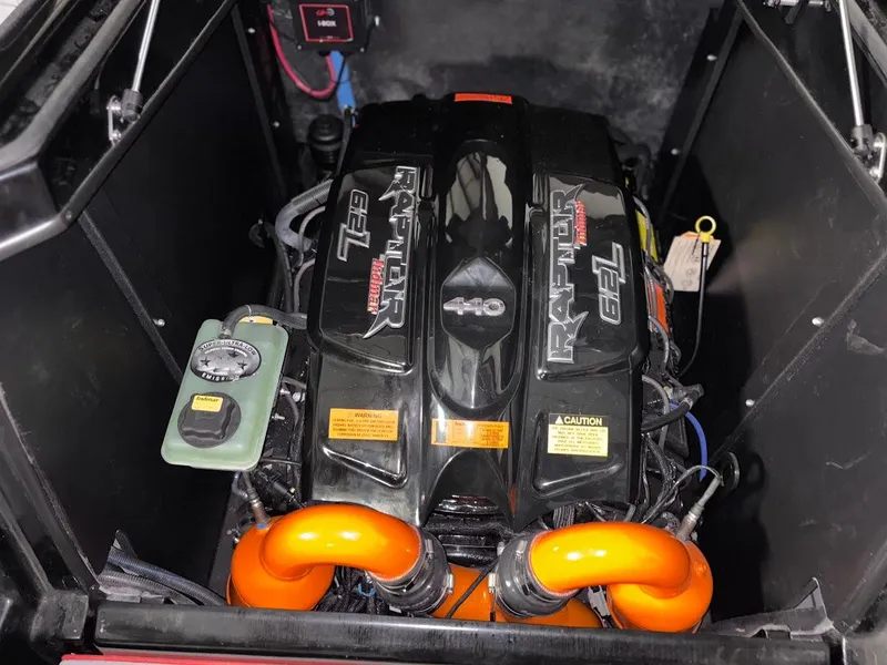 Slide: The Image of 2018 Tigé RZX3 boat engine, Raptor 6.2L, with orange components and black cover. - 17