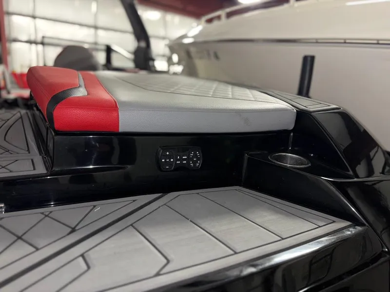 Slide: The Image of 2018 Tigé RZX3 boat interior with red and gray seating, sleek design. - 8