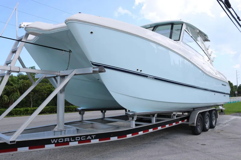 The Image of 2026 World Cat 325 DC boat on trailer, side view, outdoors. - 0