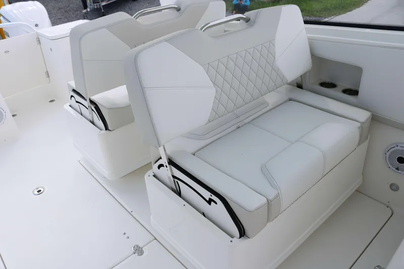 Slide: The Image of 2026 World Cat 325 DC boat interior with white cushioned seating. - 10