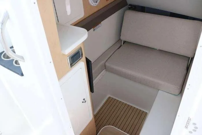 Slide: The Image of Interior cabin of 2026 World Cat 325 DC boat with seating and wood flooring. - 12
