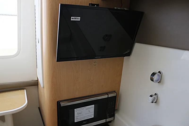 Slide: The Image of 2026 World Cat 325 DC cabin interior with beige cushions and modern amenities. - 13