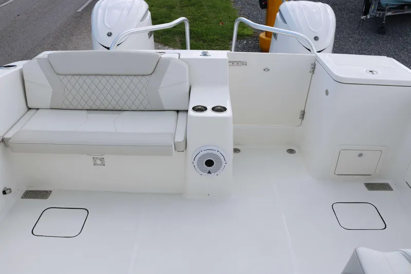 Slide: The Image of 2026 World Cat 325 DC interior seating with white cushioned seats and modern design. - 16