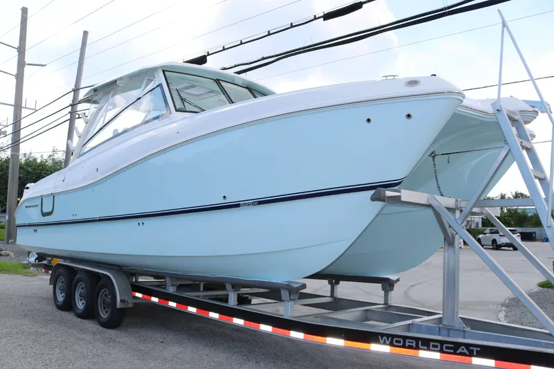 Slide: The Image of 2026 World Cat 325 DC boat on trailer, side view. - 3