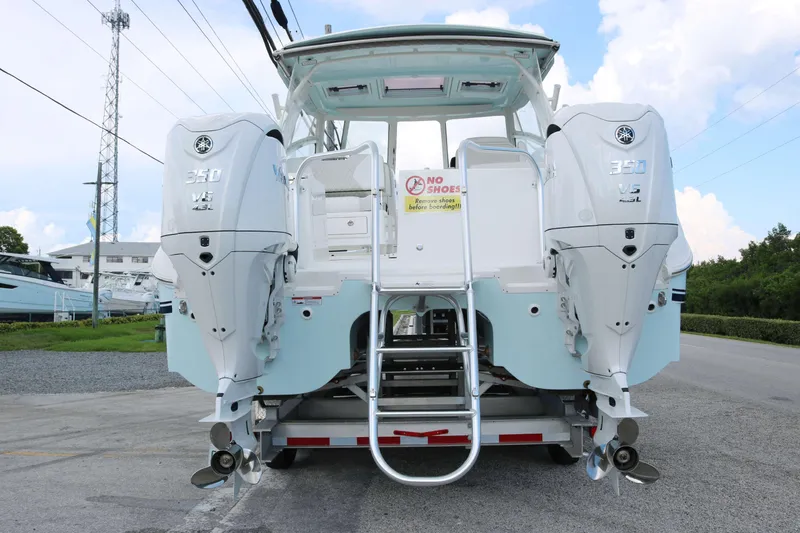 Slide: The Image of 2026 World Cat 325 DC boat with twin 350 V8 engines, rear view. - 4