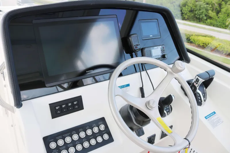 Slide: The Image of Helm of 2026 World Cat 325 DC boat with steering wheel and navigation controls. - 6