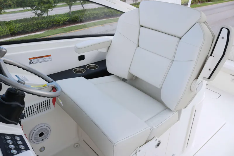 Slide: The Image of 2026 World Cat 325 DC helm seat with white upholstery and steering wheel. - 7